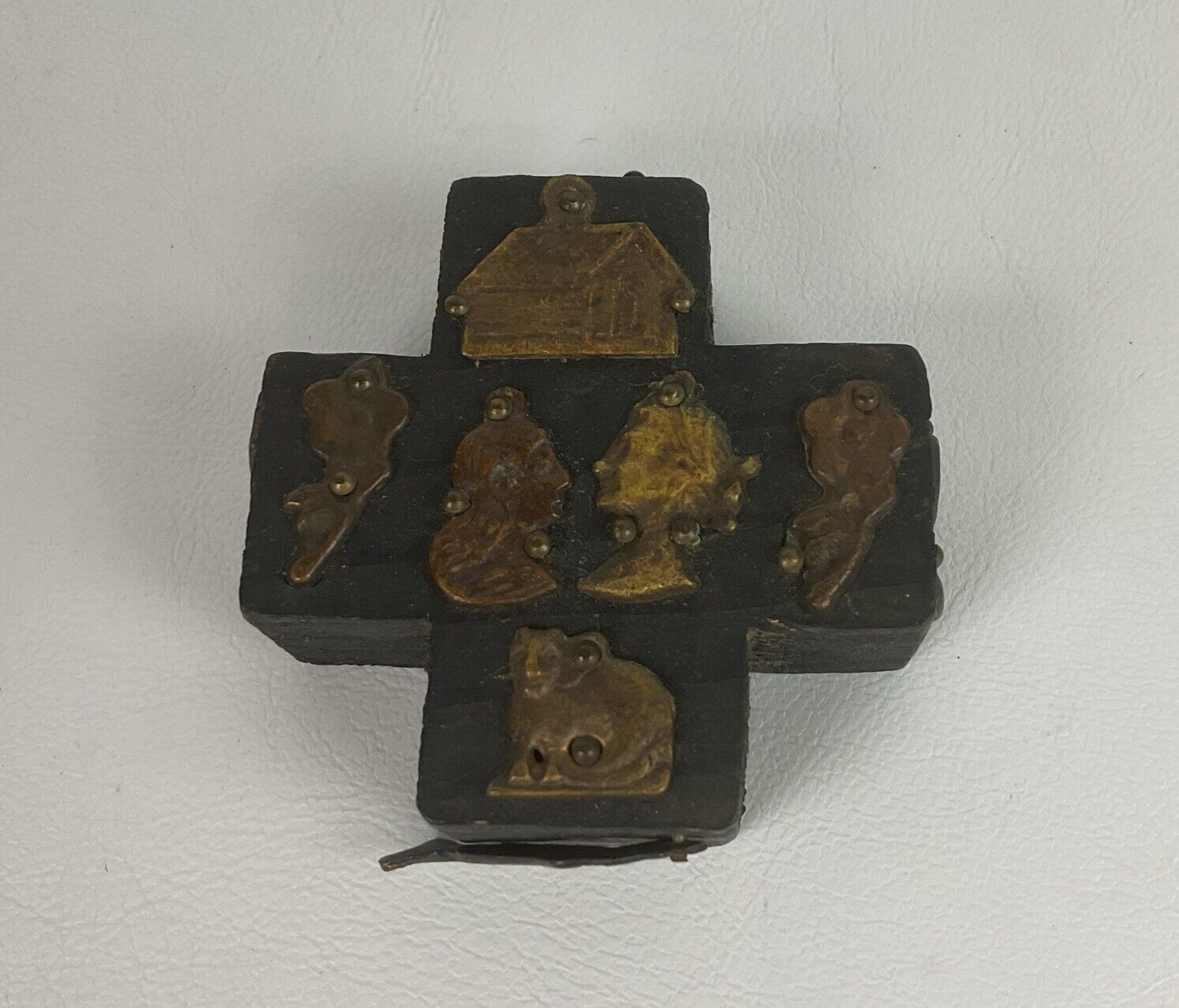 ESTELA OGAZON Mexican folk art wooden milagros cross with metal religious charms