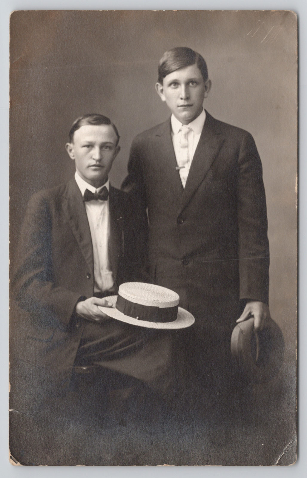 RPPC Two Young Men In Studio Holding Hats c1910 Real Photo Postcard