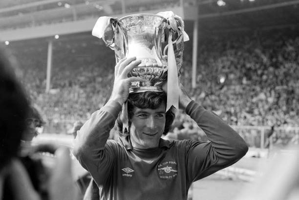 Arsenal goalkeeper Pat Jennings with the trophy after their 3-2 vic- Old Photo