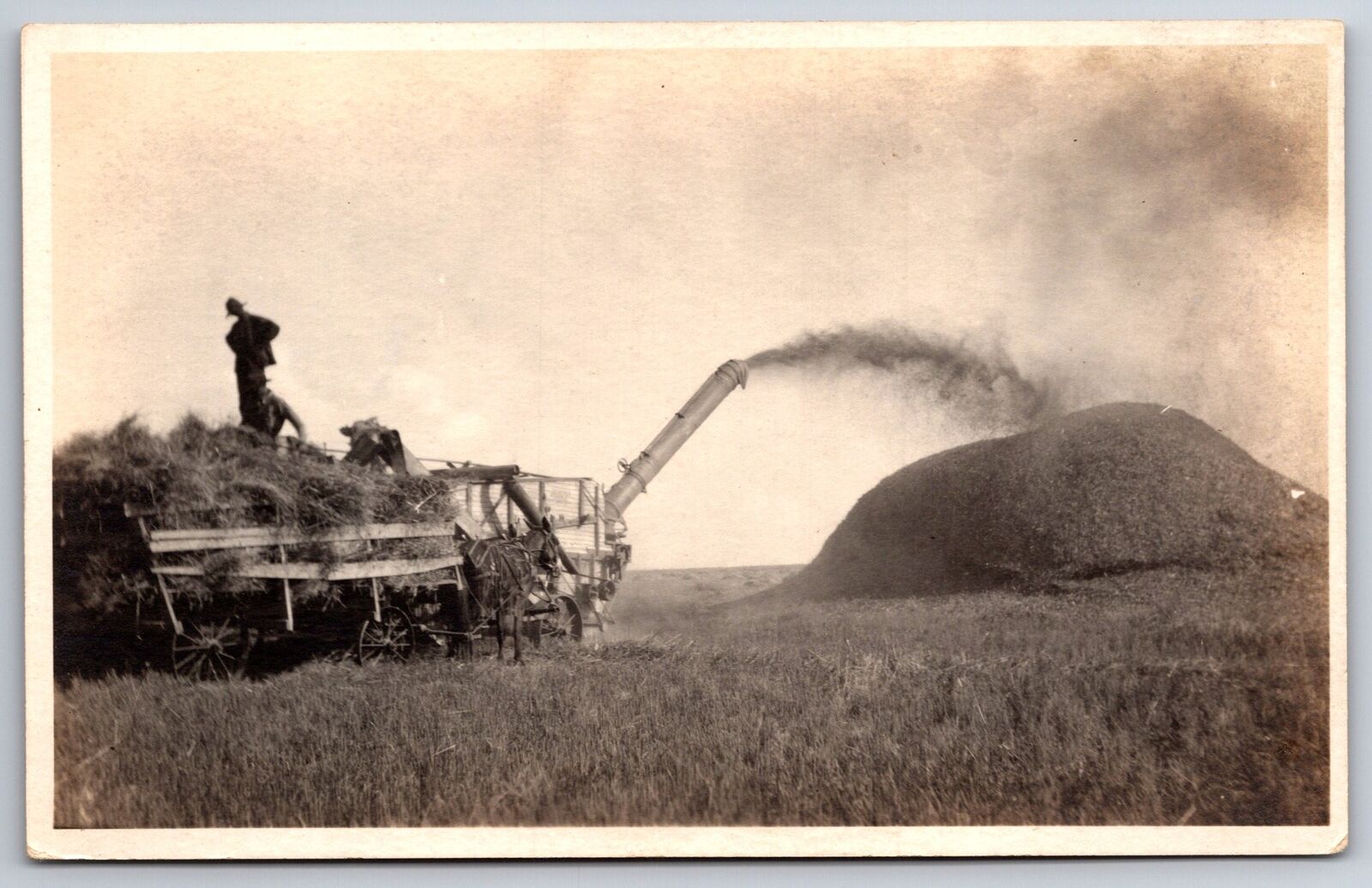 Thresher Builds Big Mound~Farmer On Wagon w/Hands On Hips Oversees~1915 RPPC