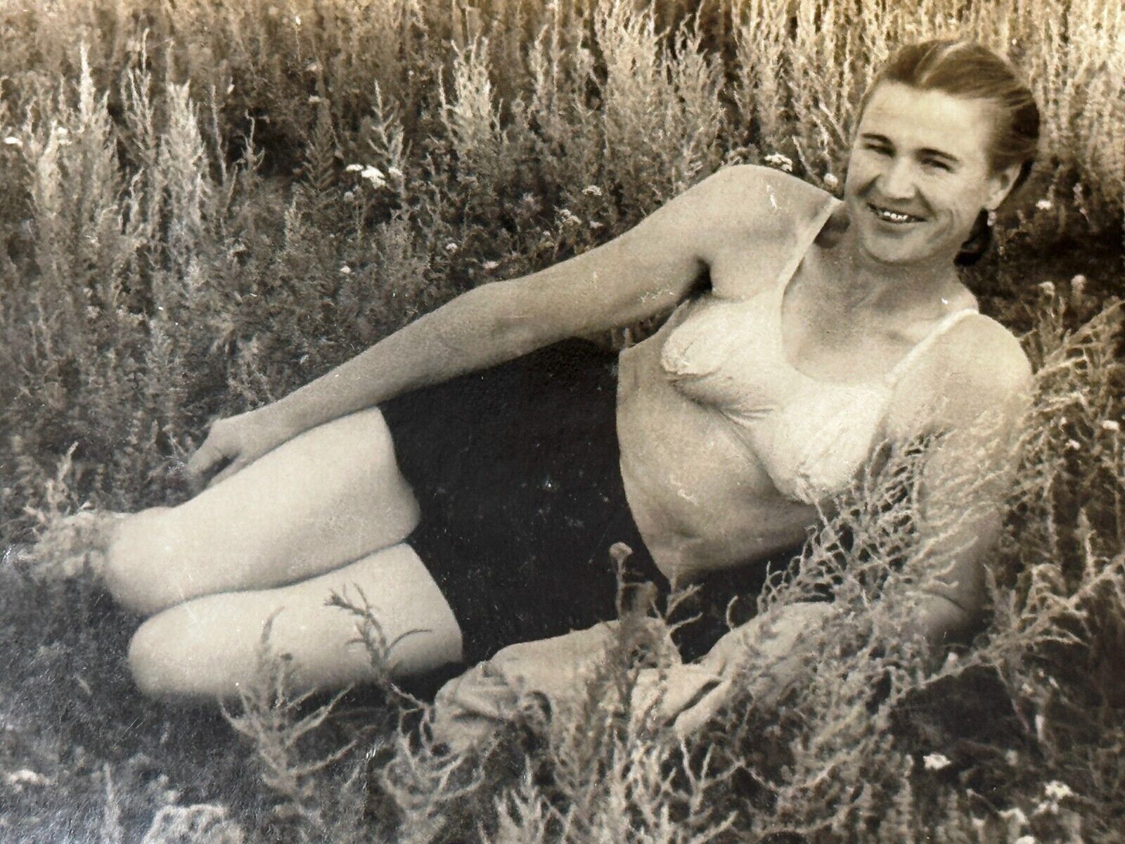 1940s Beach Smiling Metal Teeth Young Woman Bikini Lying on grass Vintage Photo