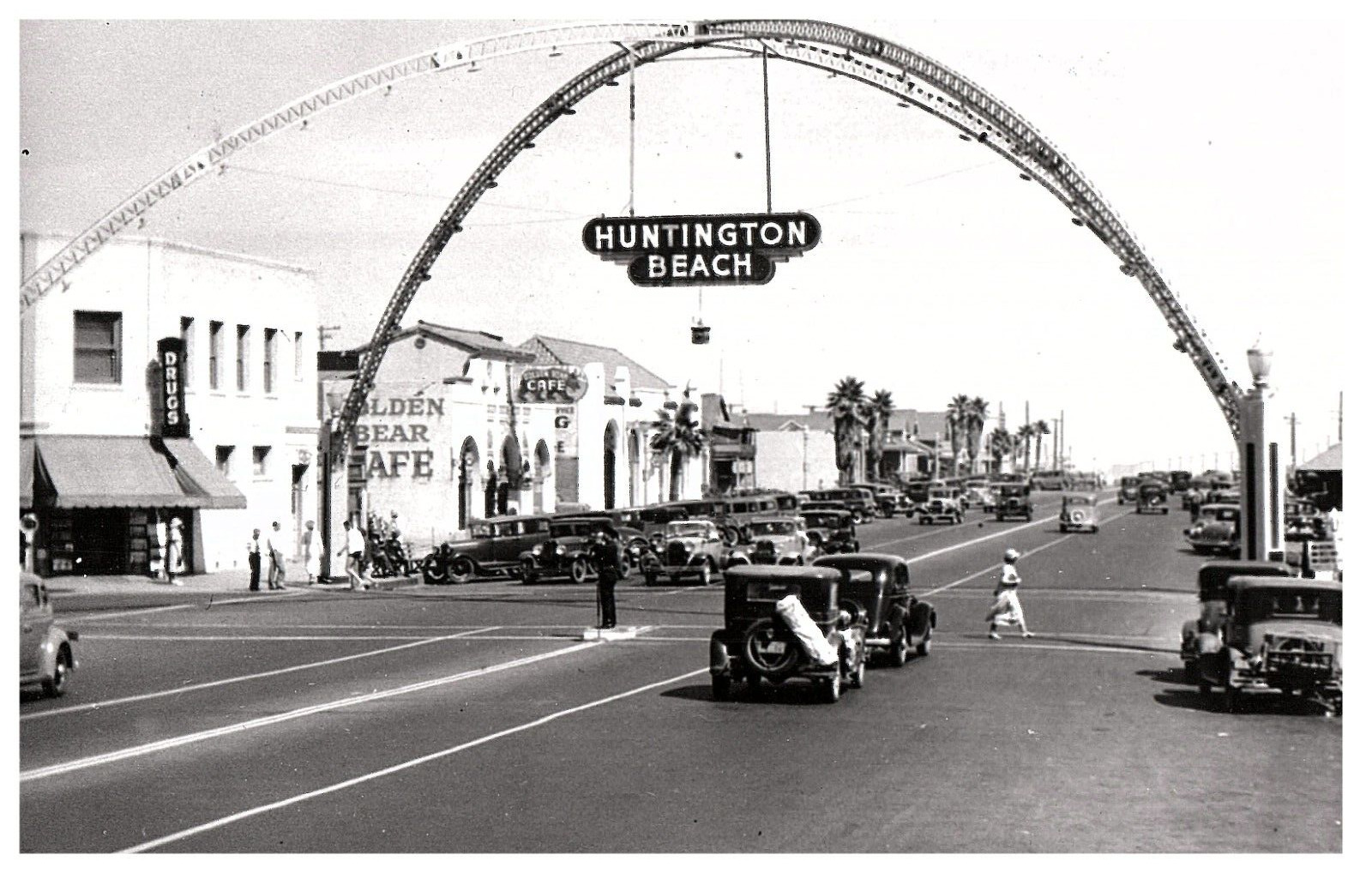 Huntington Beach CA City Entrance Main Street Shops Restaurant Old Cars Postcard