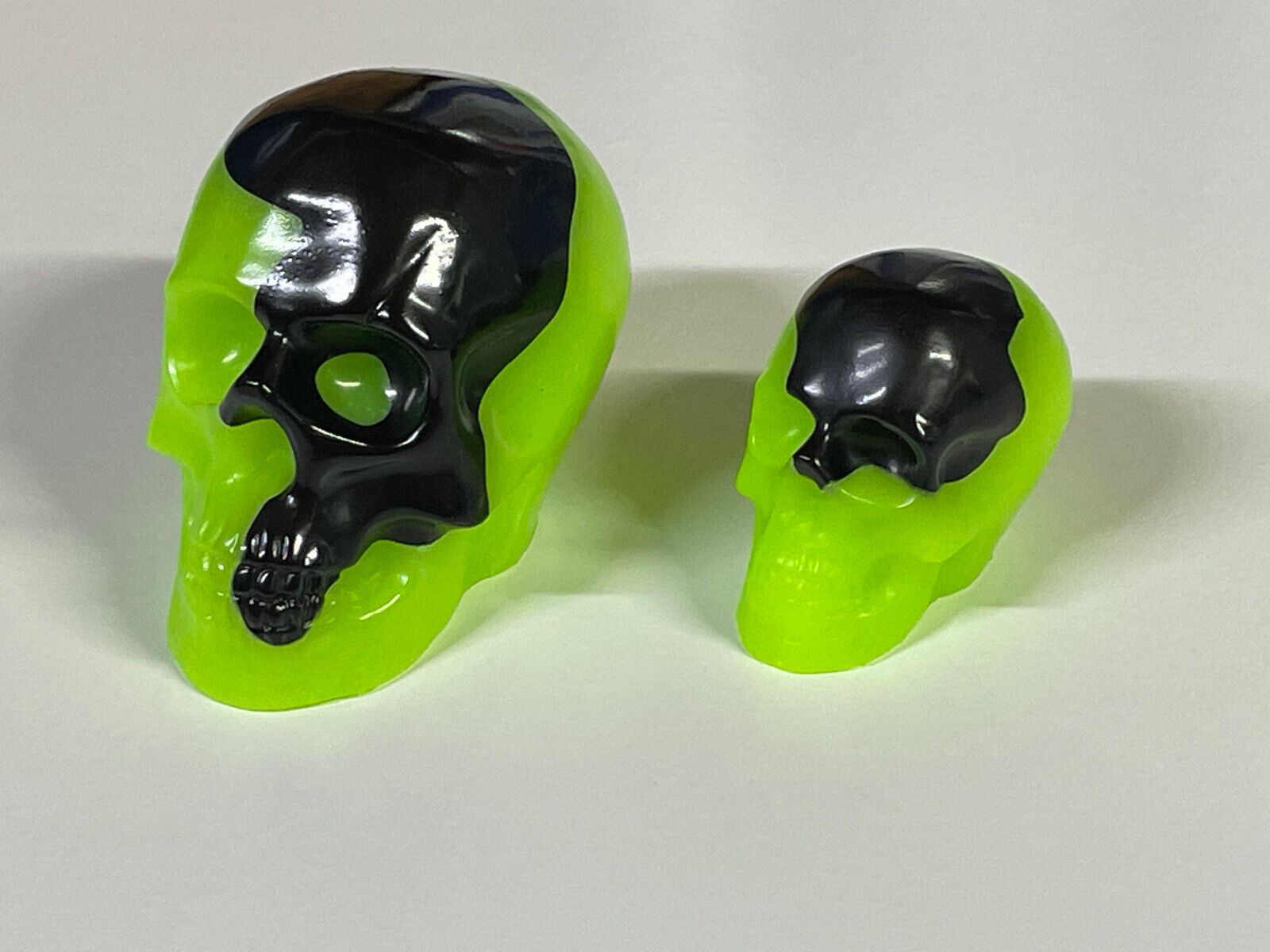 Matched pair of Green Glow in the Dark Resin Skulls.  Unique and hand made