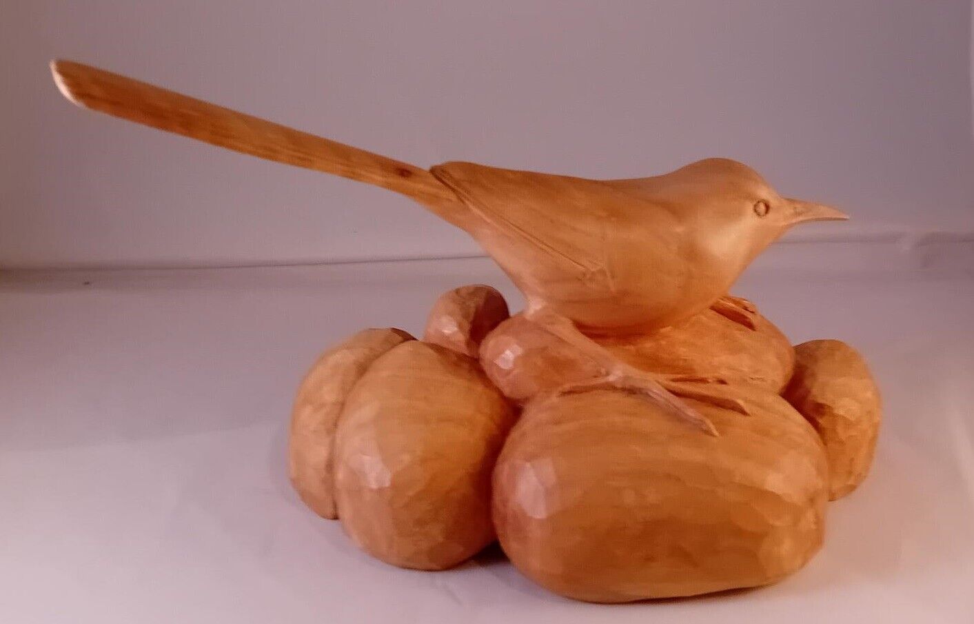 Wagtail carved out of one piece of Lime wood sitting on some pebbles