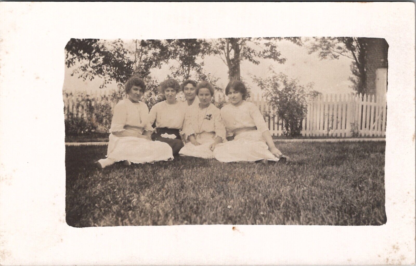 RPPC Lovely Victorian Women Seated on Lawn near Picket Fence c1915 Postcard W14