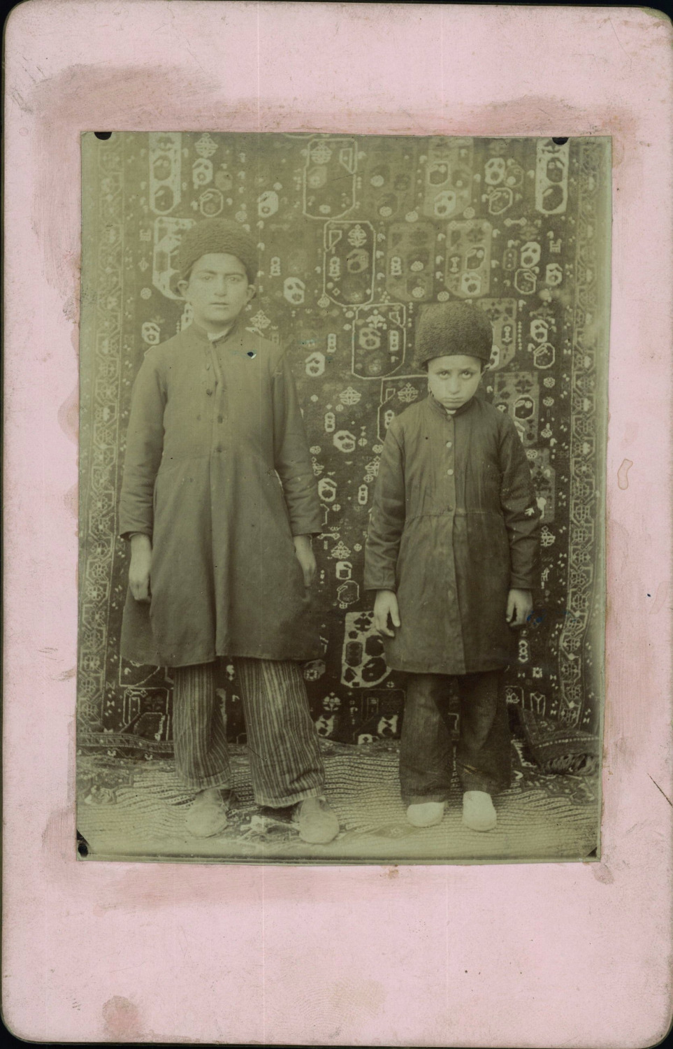 Portrait of an aristocrat Persian Qajar boy and his servant.  Photographer unkno