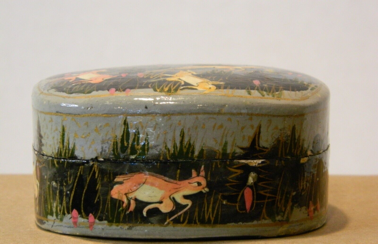 A small vintage lacquer box, hand-painted with forest animals maybe from Kashmir