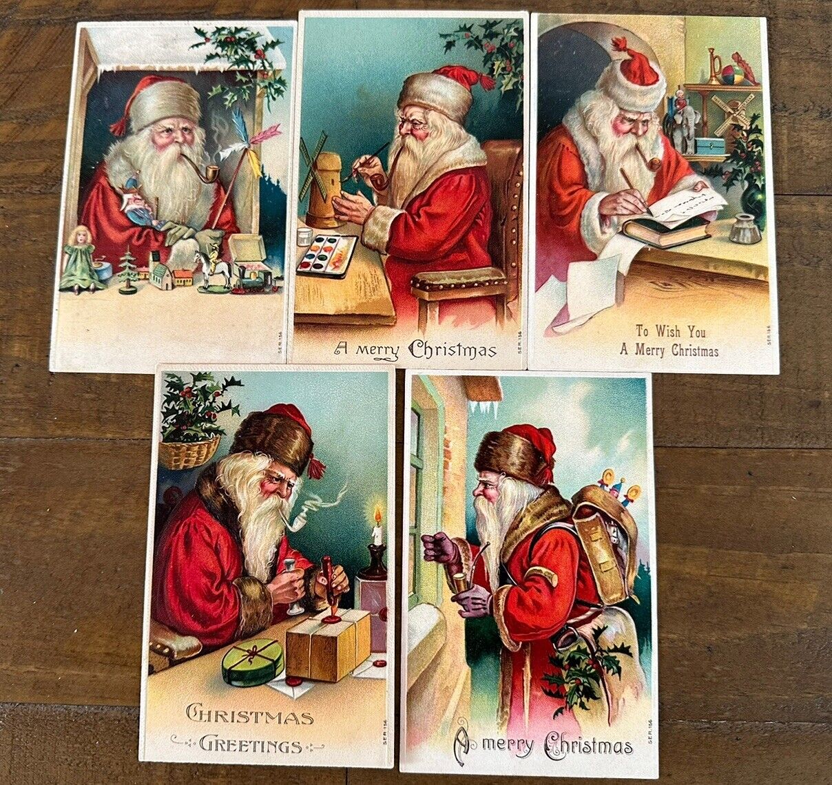 Lot of 5 SANTA CLAUS ~with Pipe~in Workshop~Toys~Antique Christmas Postcards Set