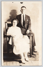 RPPC Young Couple Sitting in Studio Chair c1910 Real Photo Postcard picture