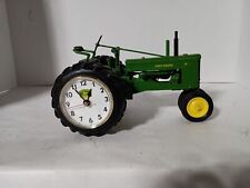 John Deere tractor with a clock in the wheel picture