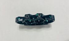 Vintage Black Metal Nuckles with Green Splatter and the word L O V E on them. picture