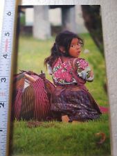 Postcard Guatemalan Girl in Traditional Attire Sitting on the Grass picture