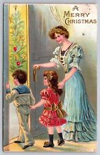 Merry Christmas Mother and Two Children Postcard picture