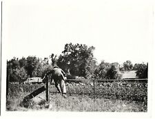 Vintage Old 1930's Abstract Photo of Man Jumping over Metal Rod Fence in Field  picture