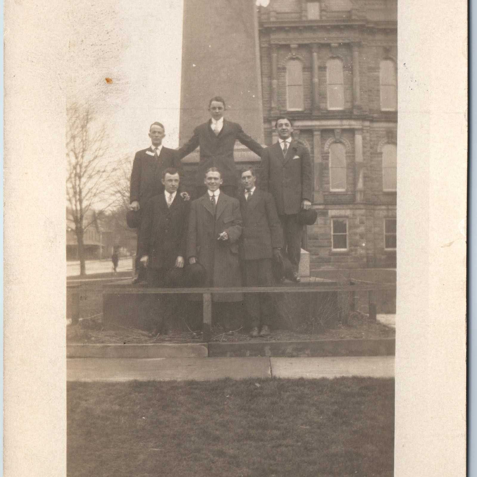 c1910s Group Men Pose RPPC Monument Obelisk Fancy Stone Bldg. Cigar Mansion A213
