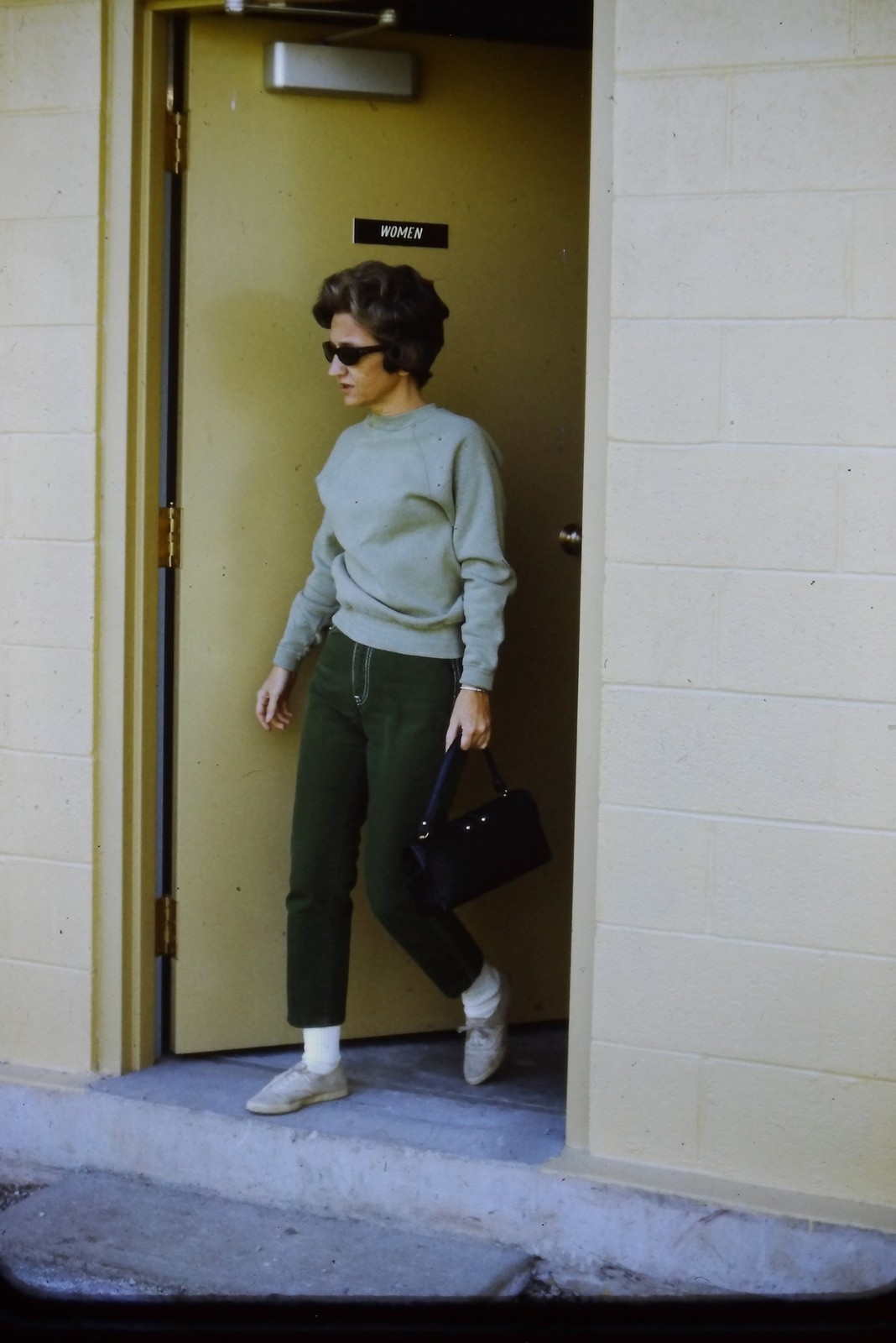c1960\'s 35mm Slide, Woman Sunglasses Handbag Pants green black Doorway Sign