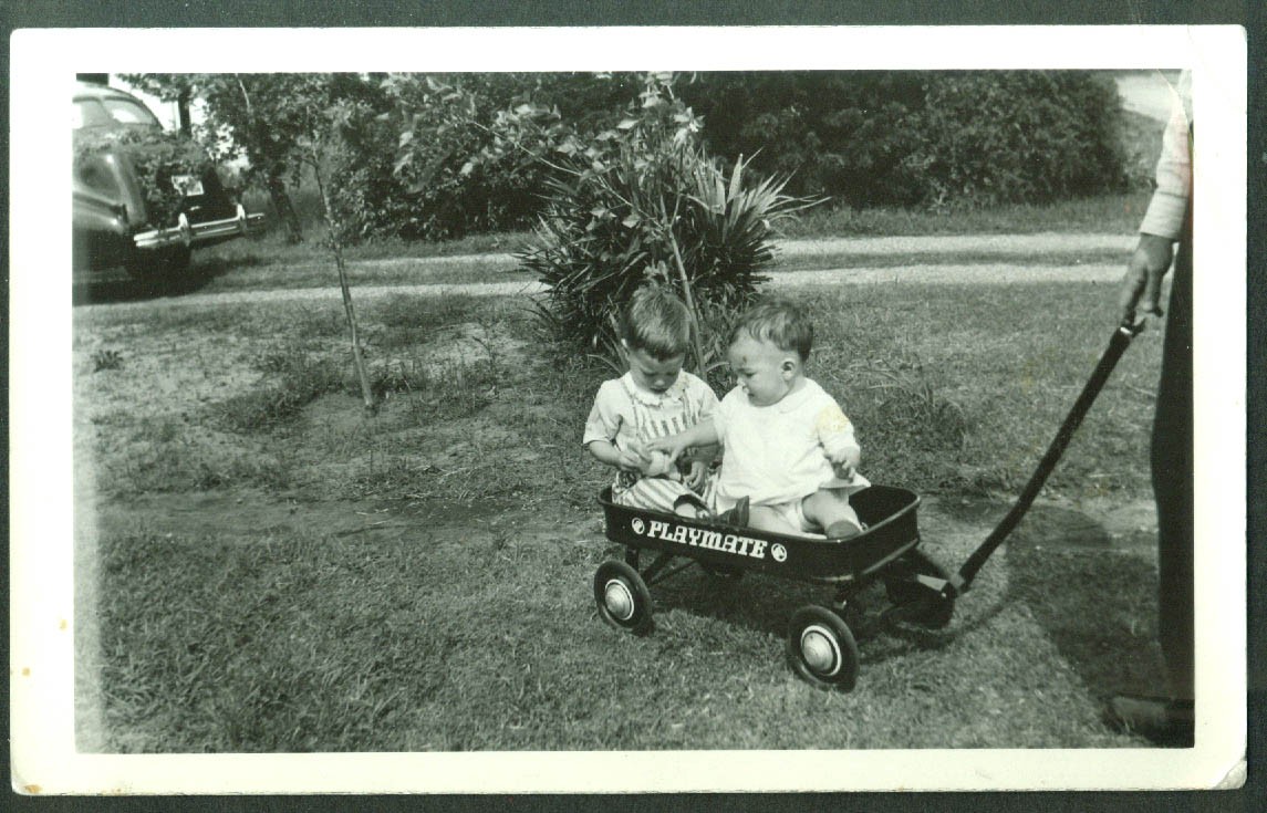 Two little boys in Playmate Coaster Wagon snapshot ca 1950s