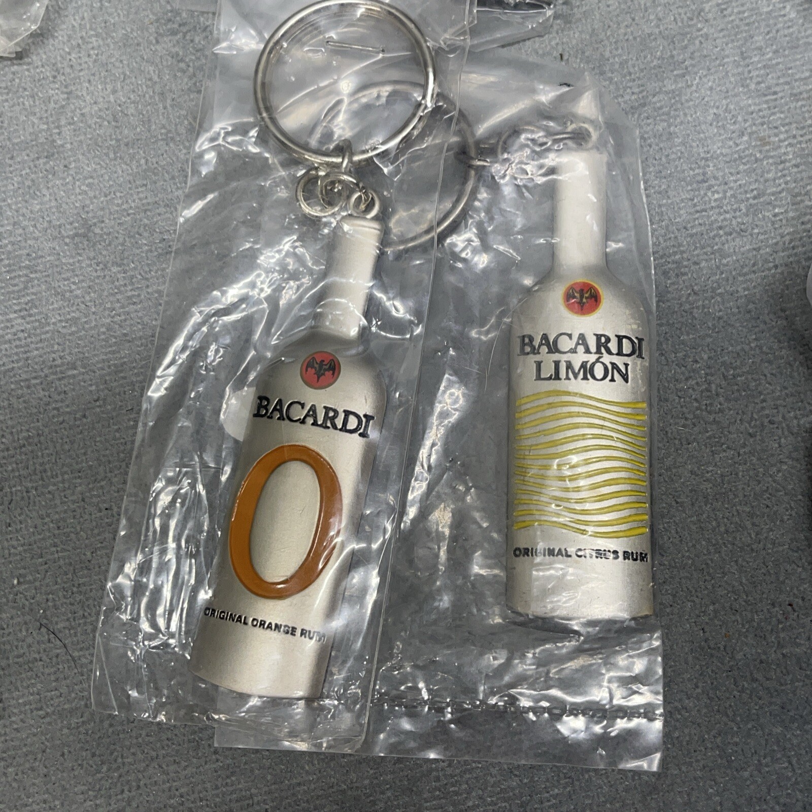 Lot Of 20 Bacardi O Orange Rum & Limon Rum Metal Keychains New Old Stock