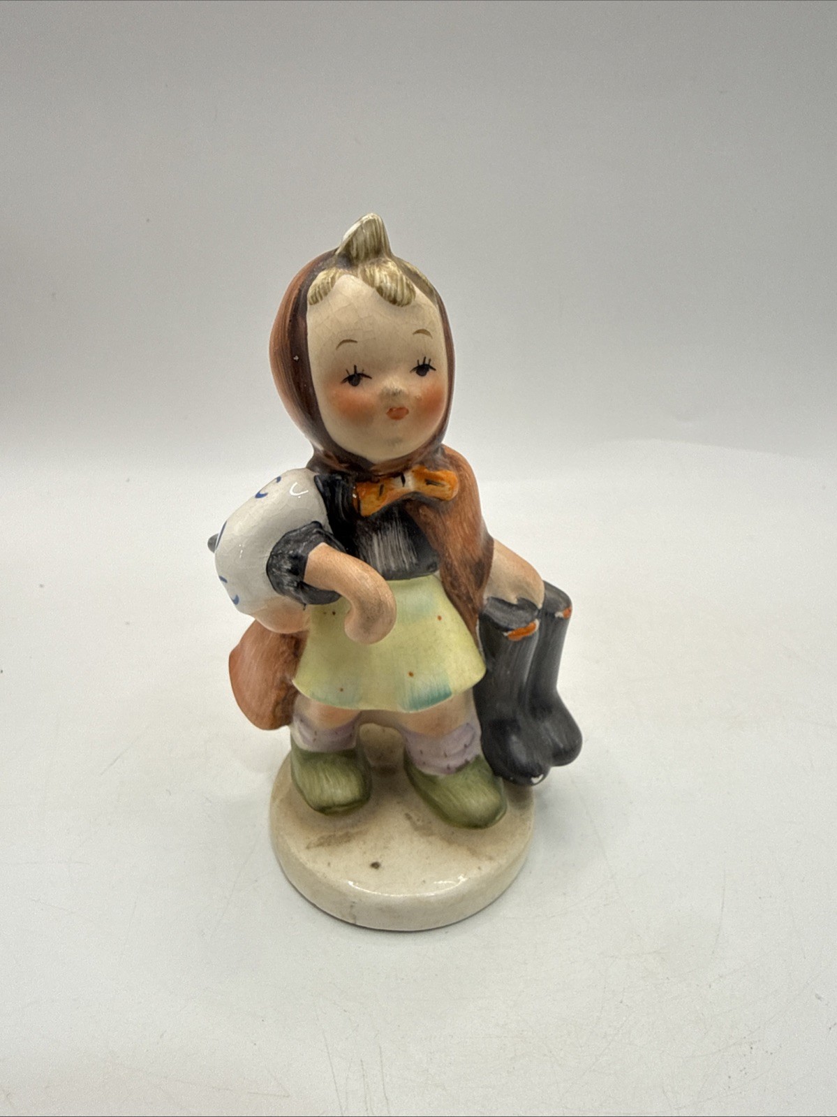 Vintage Bella Clara Girl Carrying Boots Hand Painted Ceramic Figurine 4” *