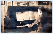 RPPC MAN PLAYING PIANO*METRONOME*FRINGED PIANO SCARF*SHEET MUSIC*REAL PHOTO PC picture