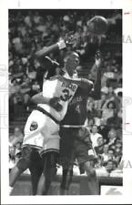 1993 Press Photo Ron Harper wraps up Hakeem Olajuwon during game at The Summit picture